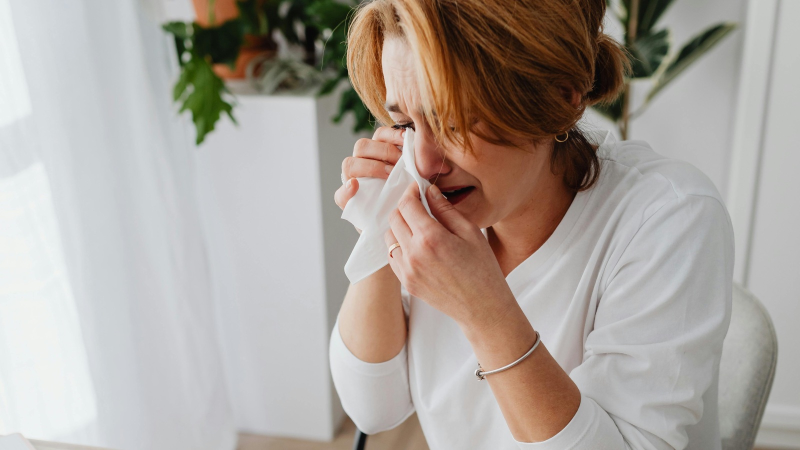 En grædende kvinde som et eksempel på et offer for økonomisk vold.