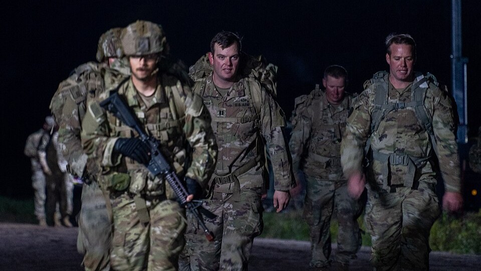 Soldiers of the 1st Cavalry Division and 4th Infantry Division continue a 12-mile ruck march during Expert Infantry, Soldier, and Field Medical Badge (E3B) qualifications near Drawsko Pomorskie Combat Training Center, Poland, Oct. 18, 2024. U.S. Army photo by Pfc. Hector Blanco